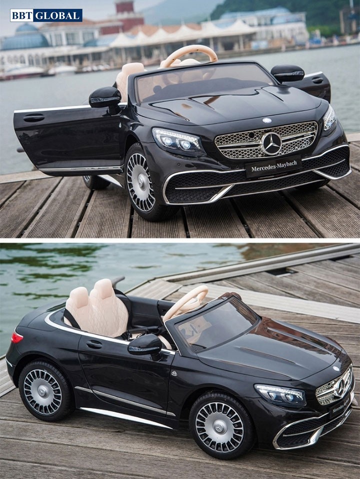 Một bé gái tạo dáng bên chiếc xe ô tô điện trẻ em Mercedes Maybach S650