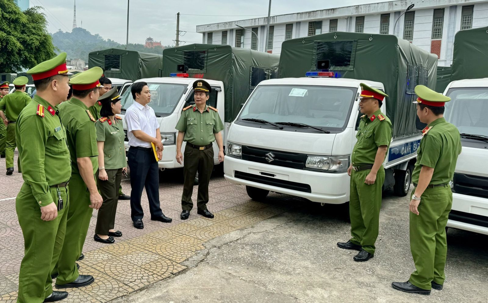 Các chiến sĩ Công an xã tiếp nhận và kiểm tra xe ô tô công an Suzuki Carry mới được trang cấp để phục vụ công tác.