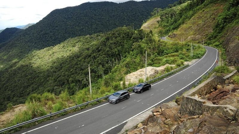 Hai chiếc xe ô tô đỗ an toàn trên một con đường đồi núi, minh họa kỹ thuật đỗ xe ô tô đúng cách.